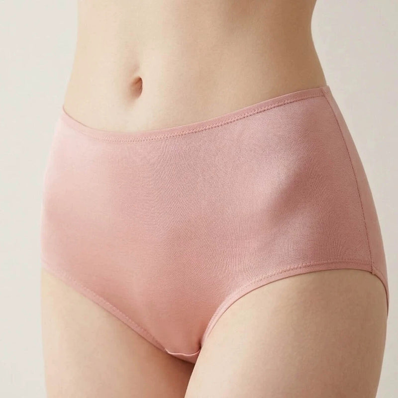 Adult model wearing the pale-pink high-rise silk brief
