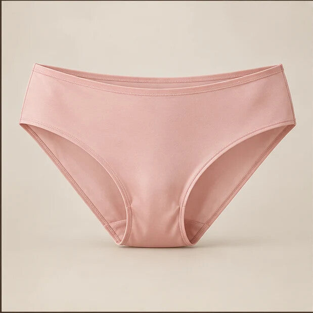 Blush seamless silk bikini photographed on a warm neutral background