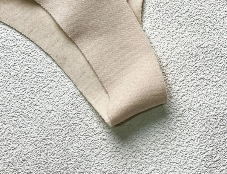 Close view of the wide shoulder strap and soft fabric